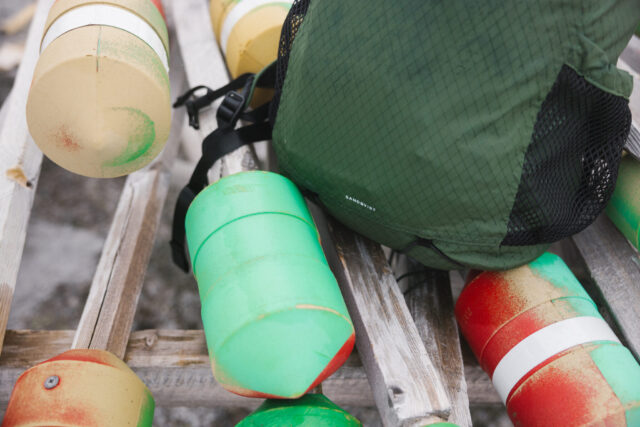 a group of buoys on a wooden shelf