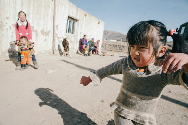a child running in a dirt area