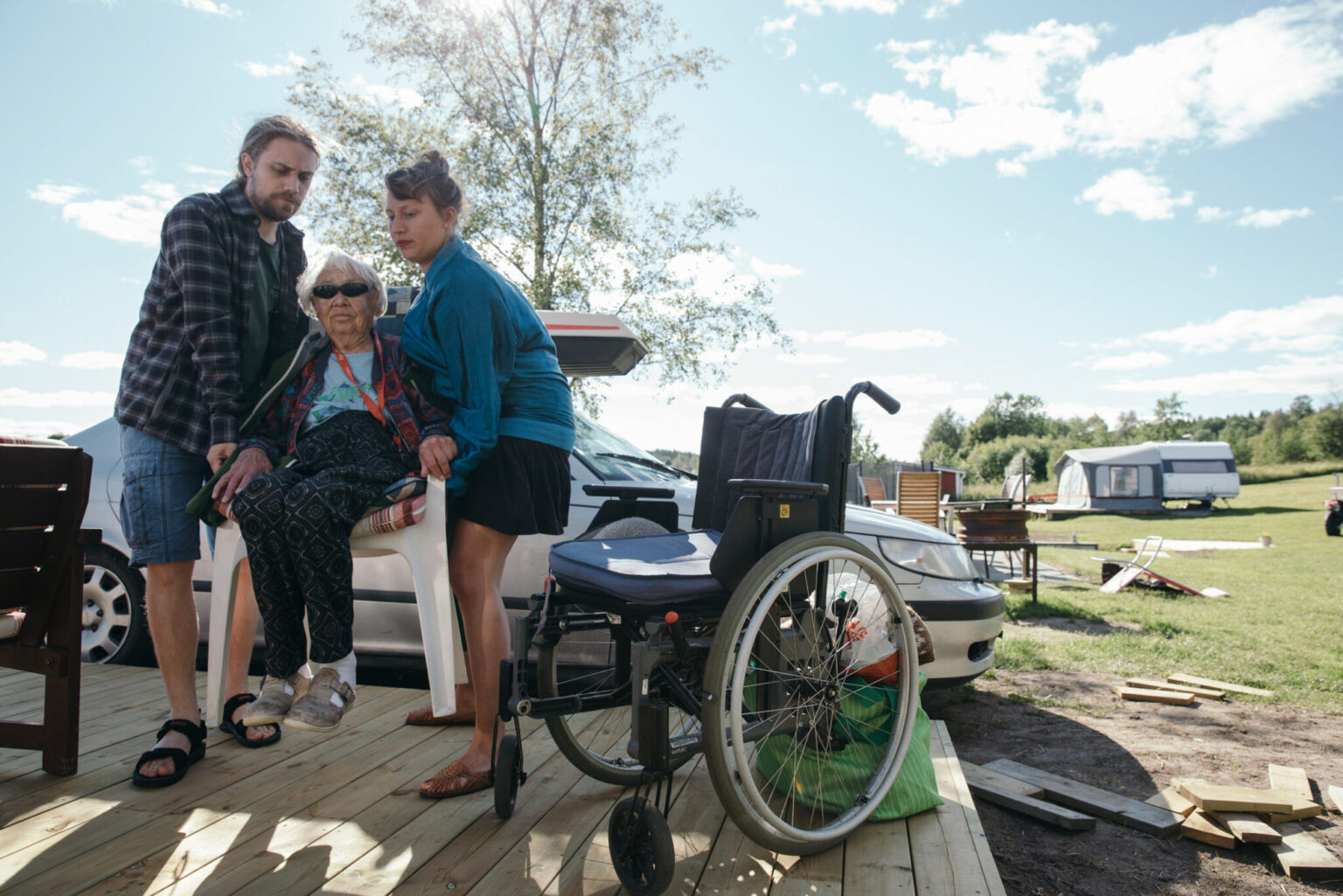 a group of people outside with a wheelchair