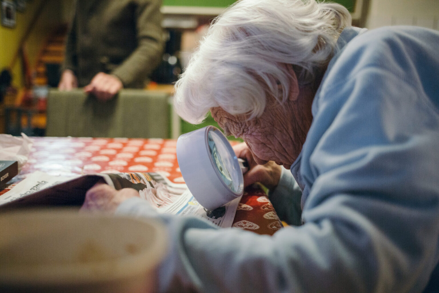 an old woman looking at a magnifying glass