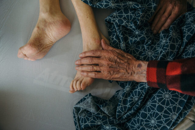 a person's hand on a person's foot