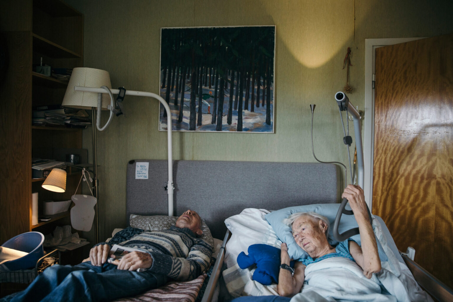 a man and woman lying in a hospital bed