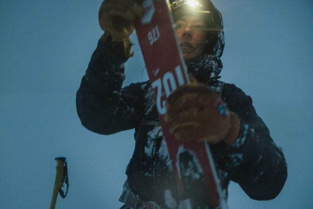 a person holding a red and white ski board
