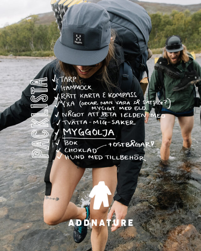 a woman with a backpack walking in water
