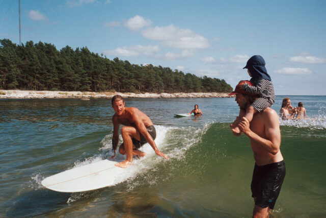 a group of people surfing in the water