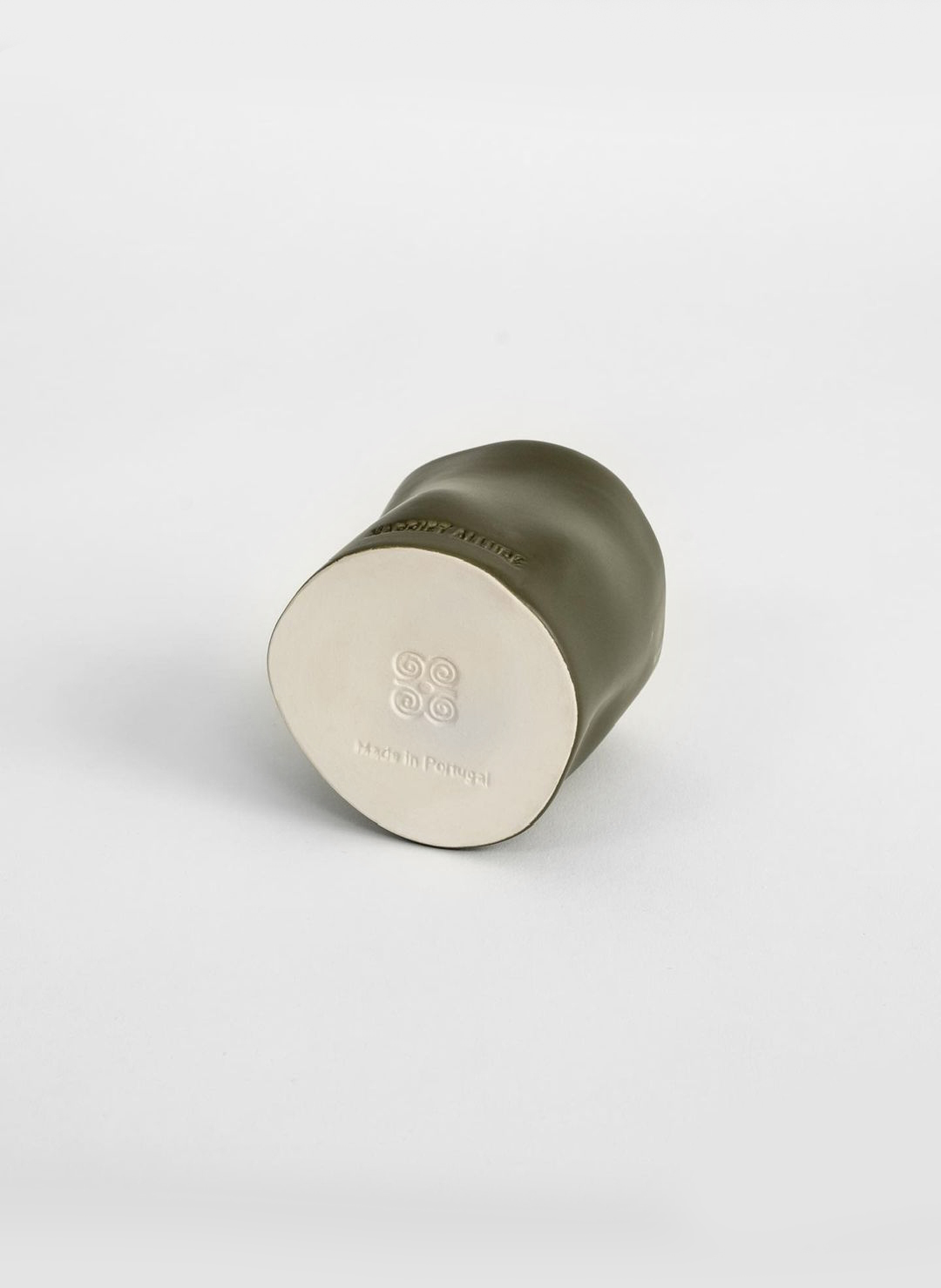 a small green and white cup