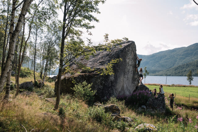a group of people climbing a large rock