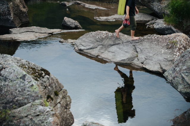 a person walking on rocks in water