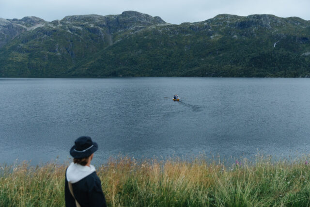 a person looking at a boat in the water