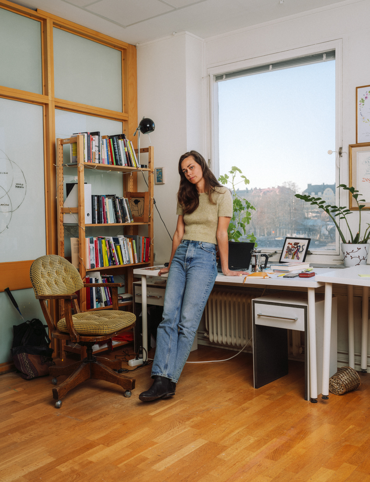 a woman leaning on a desk