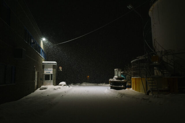a snow falling on a street