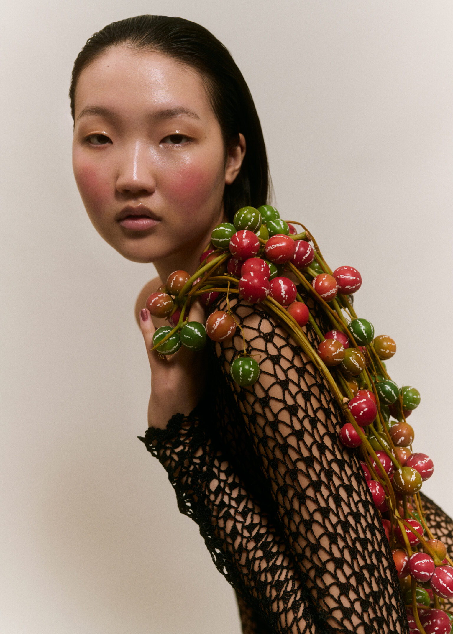 a woman with a bunch of fruit on her shoulder