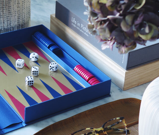 a game board with dice and glasses on a table