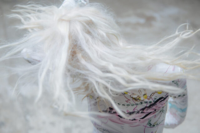 a close up of a doll's hair