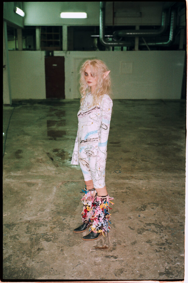 a woman in garment with long blonde hair