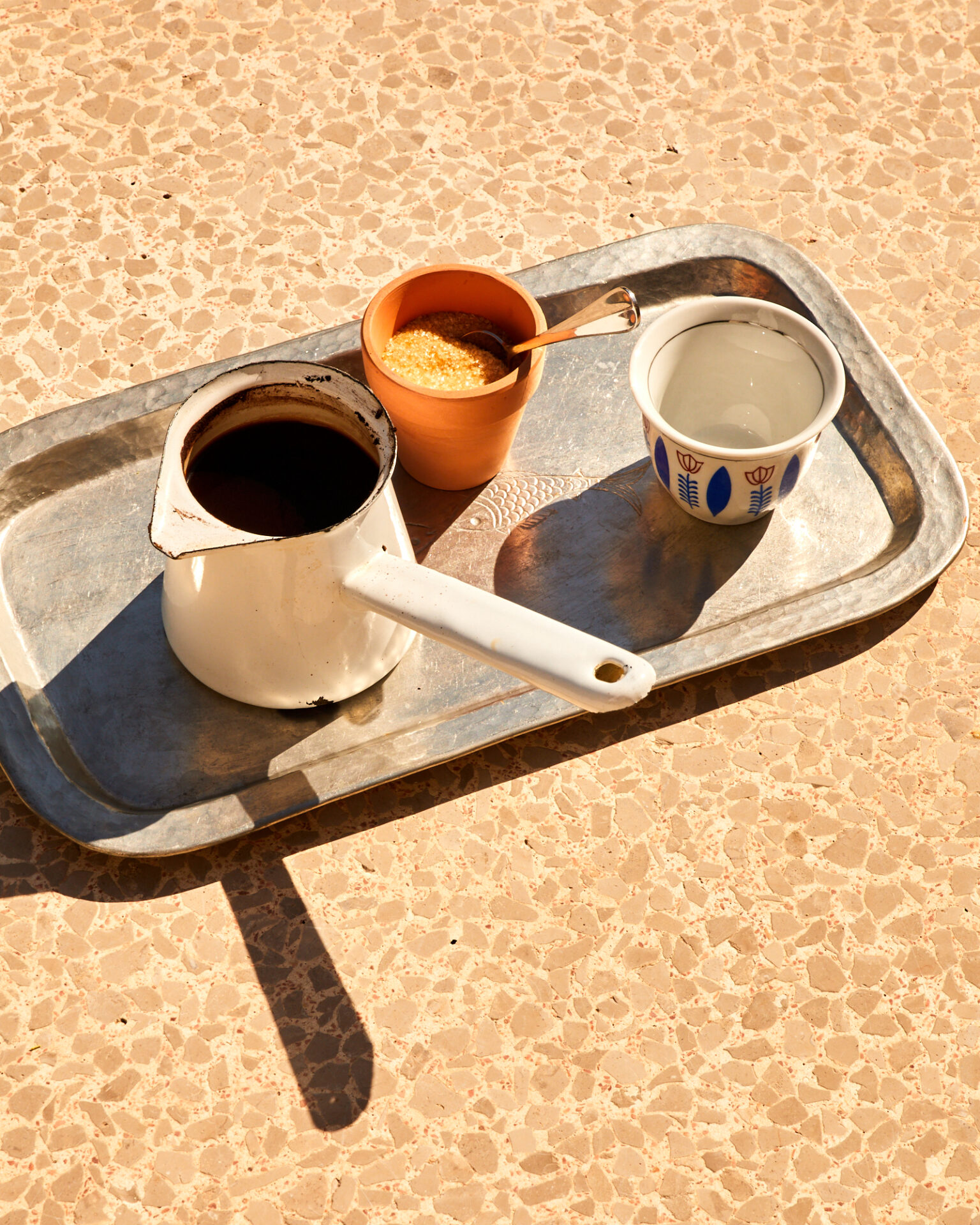 a tray with a teapot and cups on it