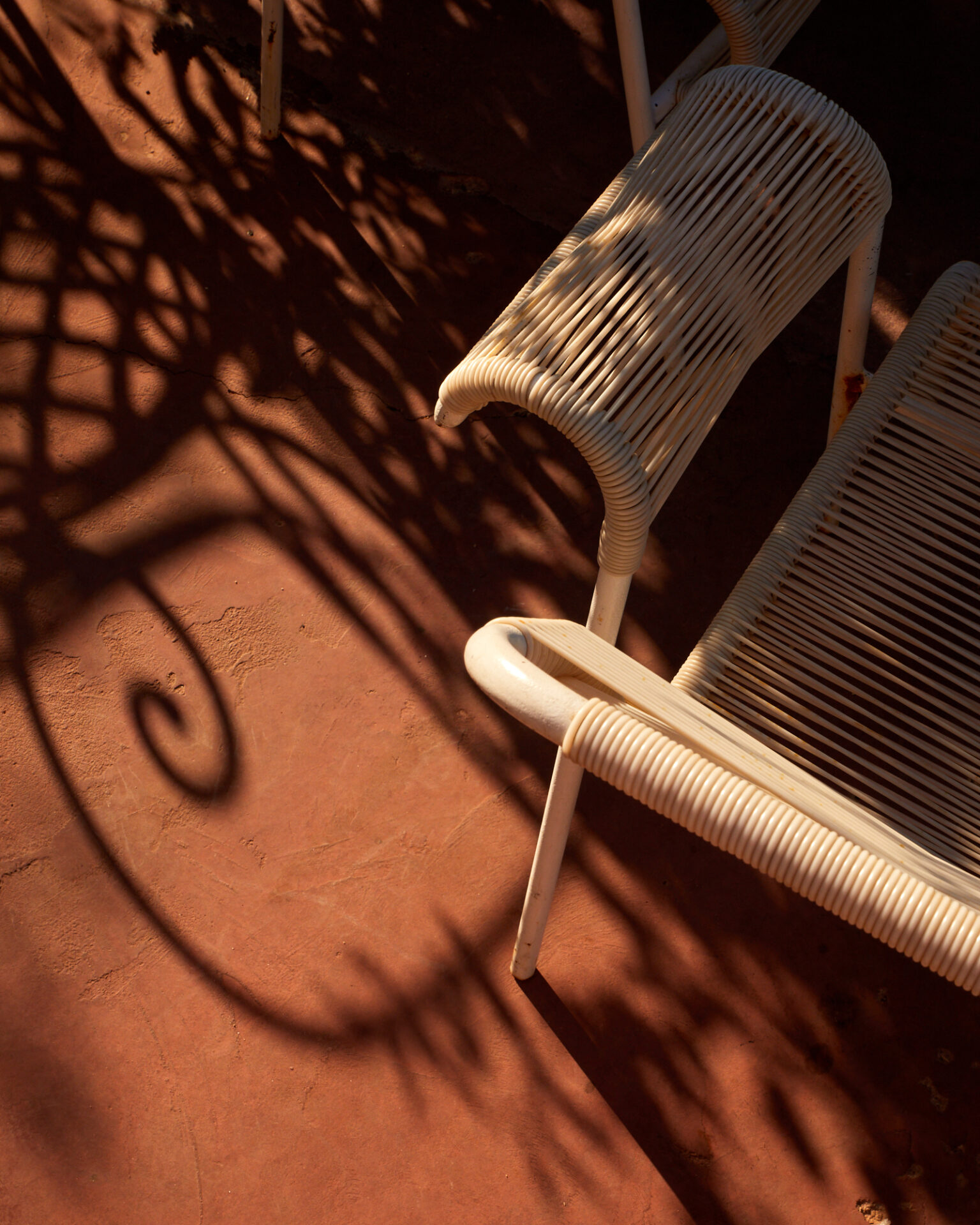 a white chair on a red surface