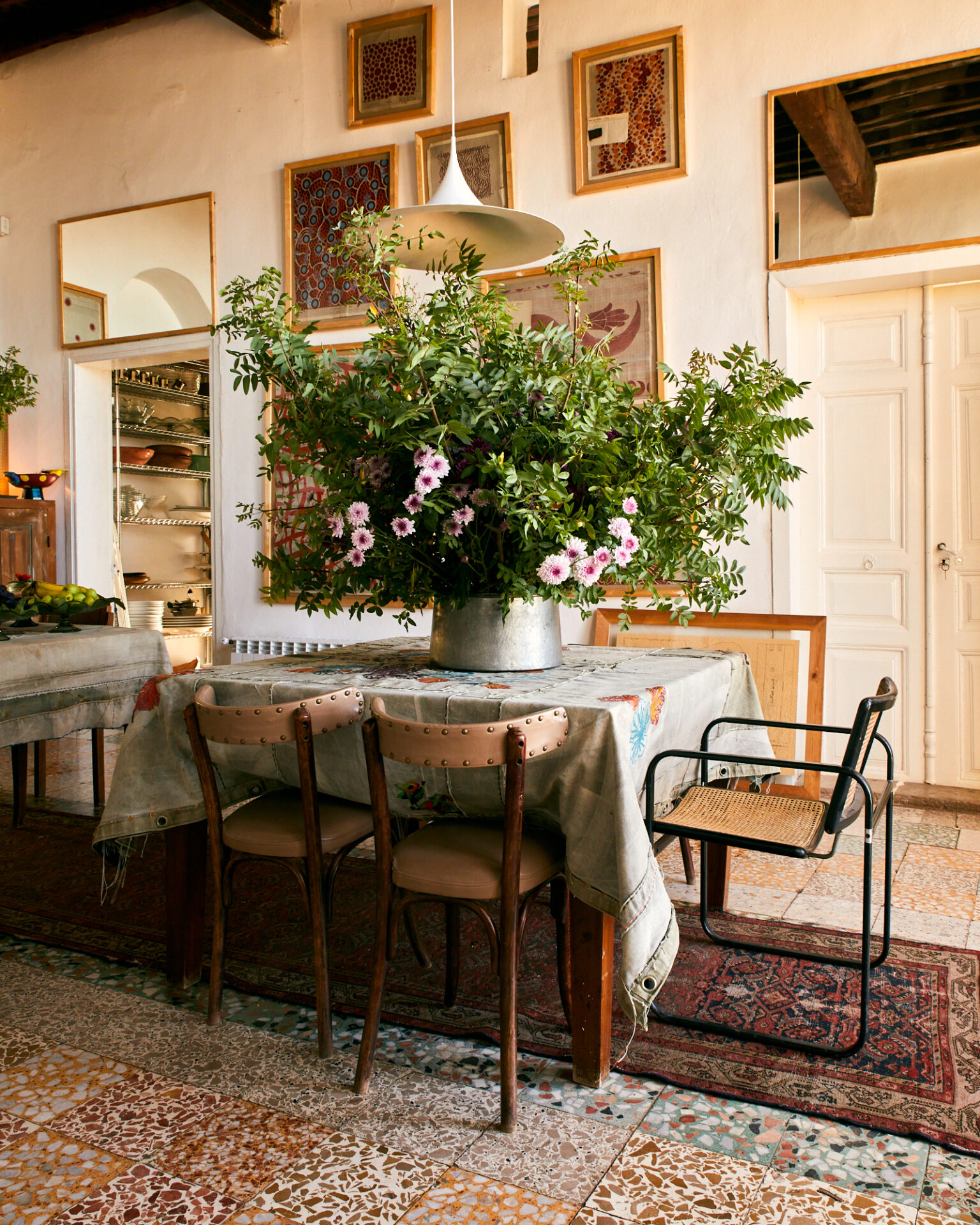 a table with a pot of flowers on it