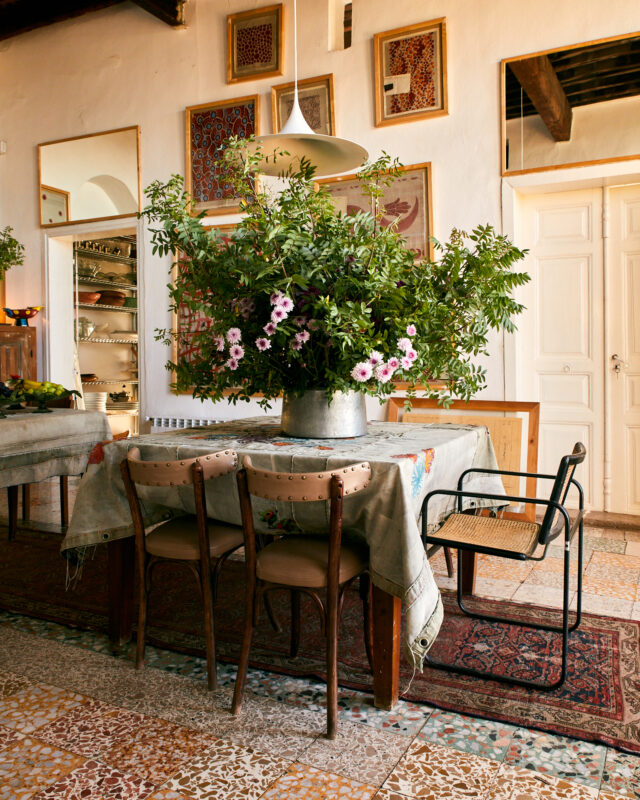 a table with a pot of flowers on it