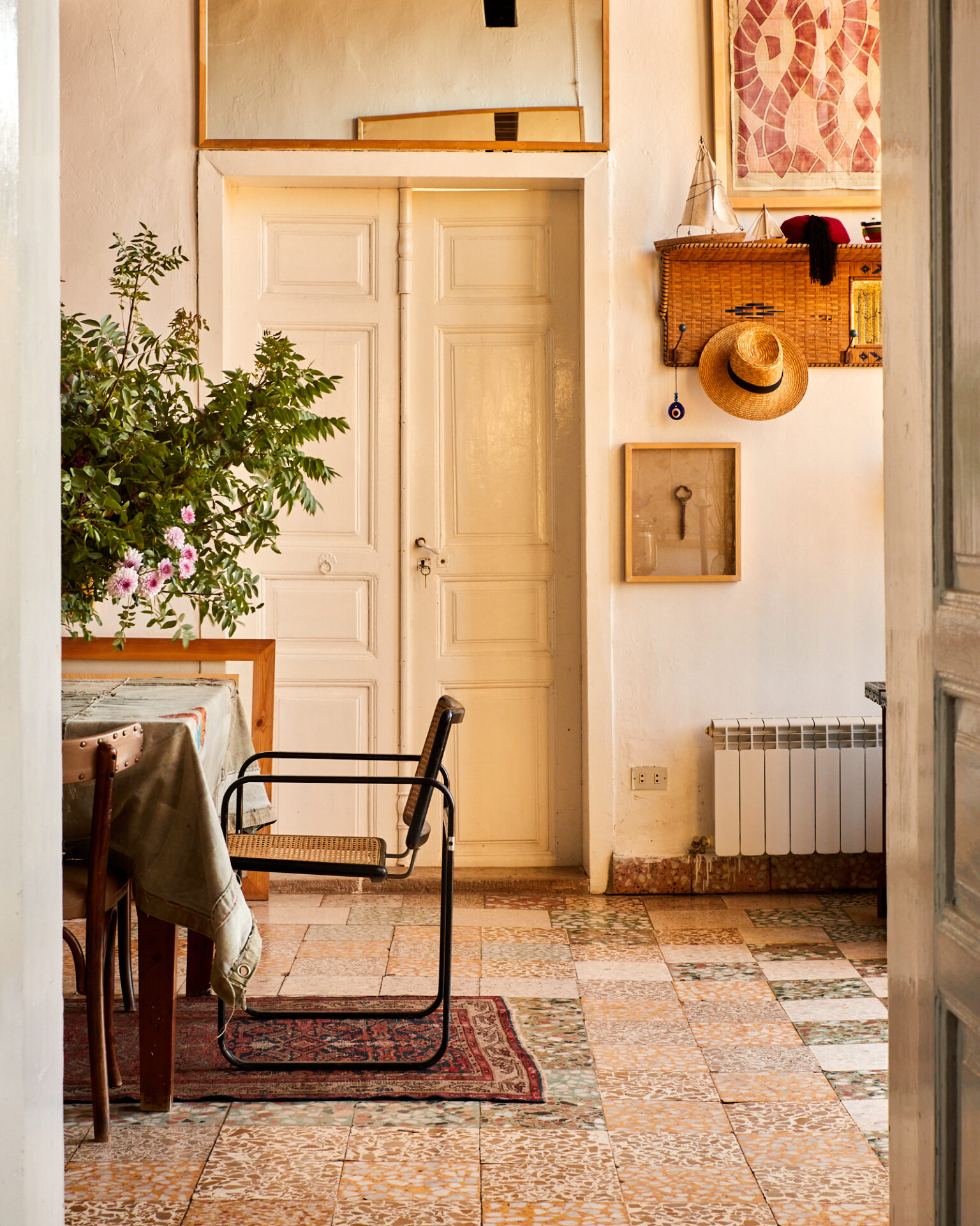 a room with a table and chairs and a rug