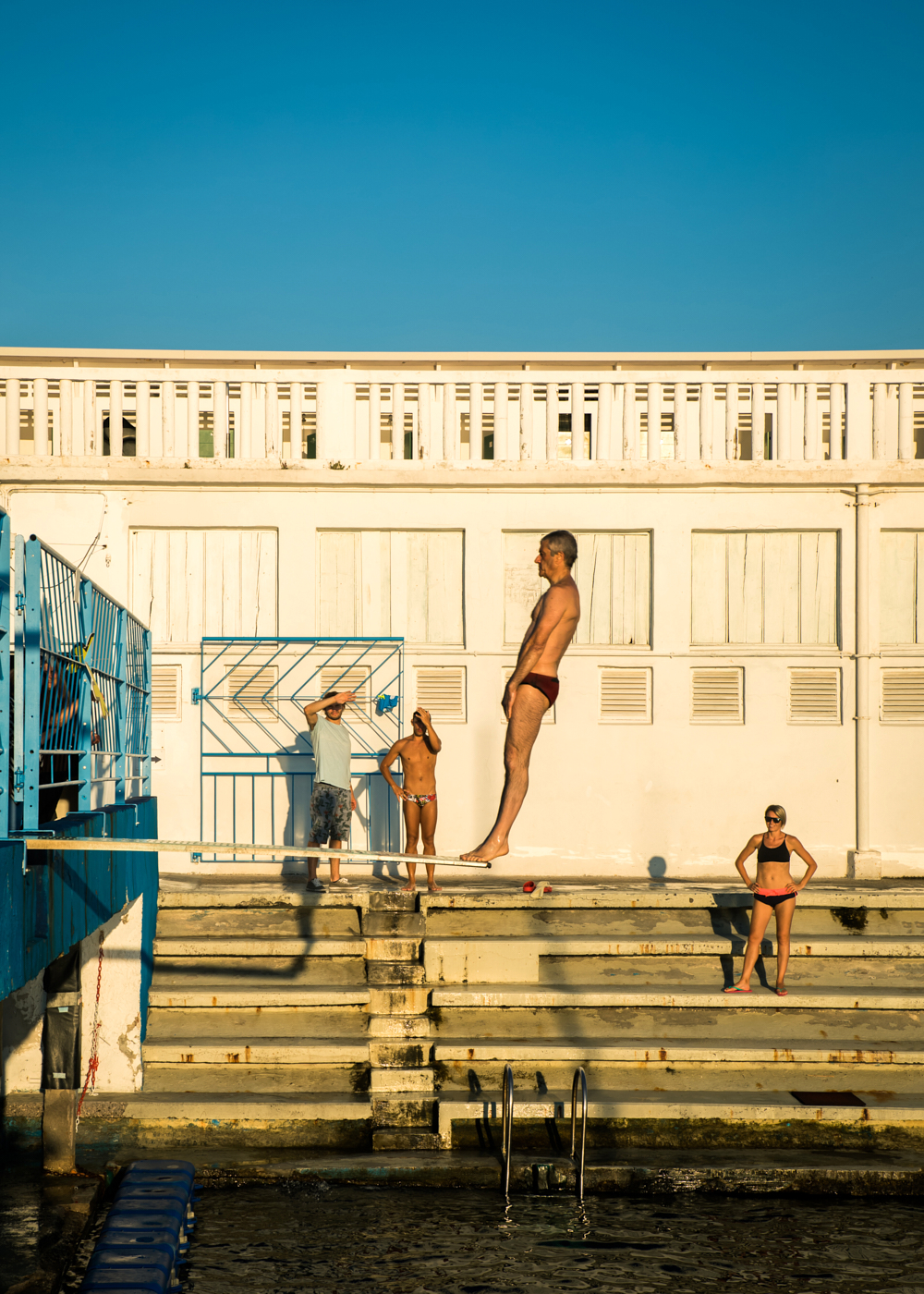 a man jumping off a beach volley ball