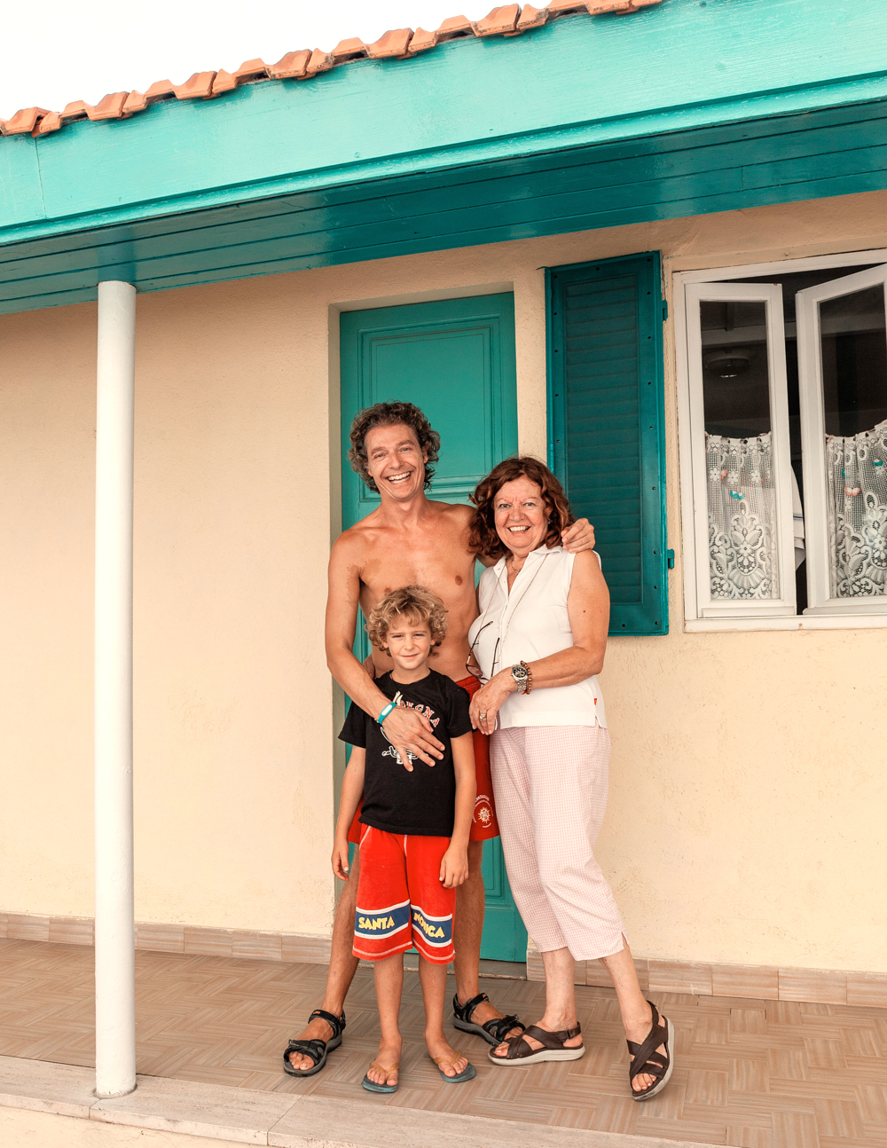 a man and woman standing in front of a house