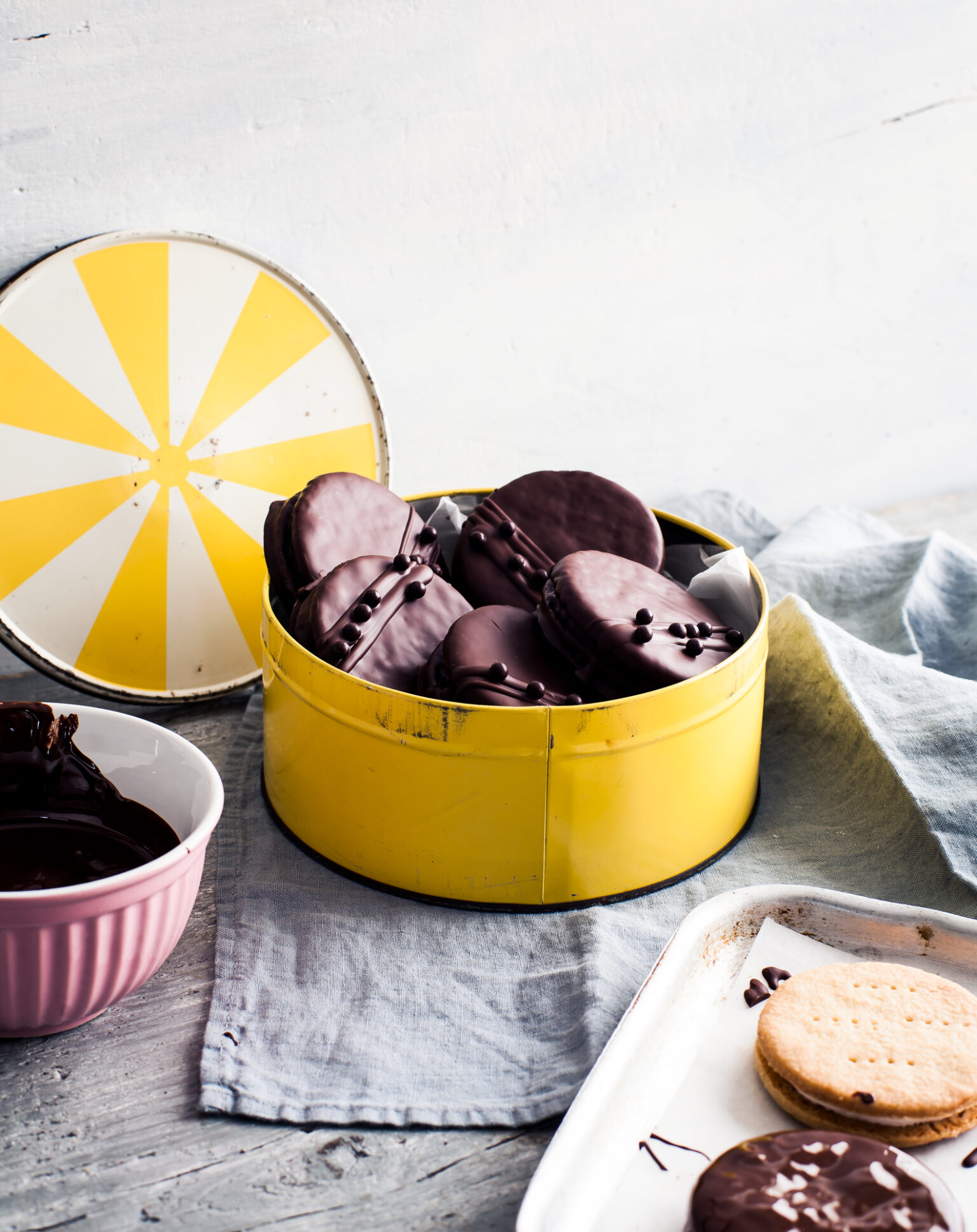 a yellow tin with chocolate cookies in it
