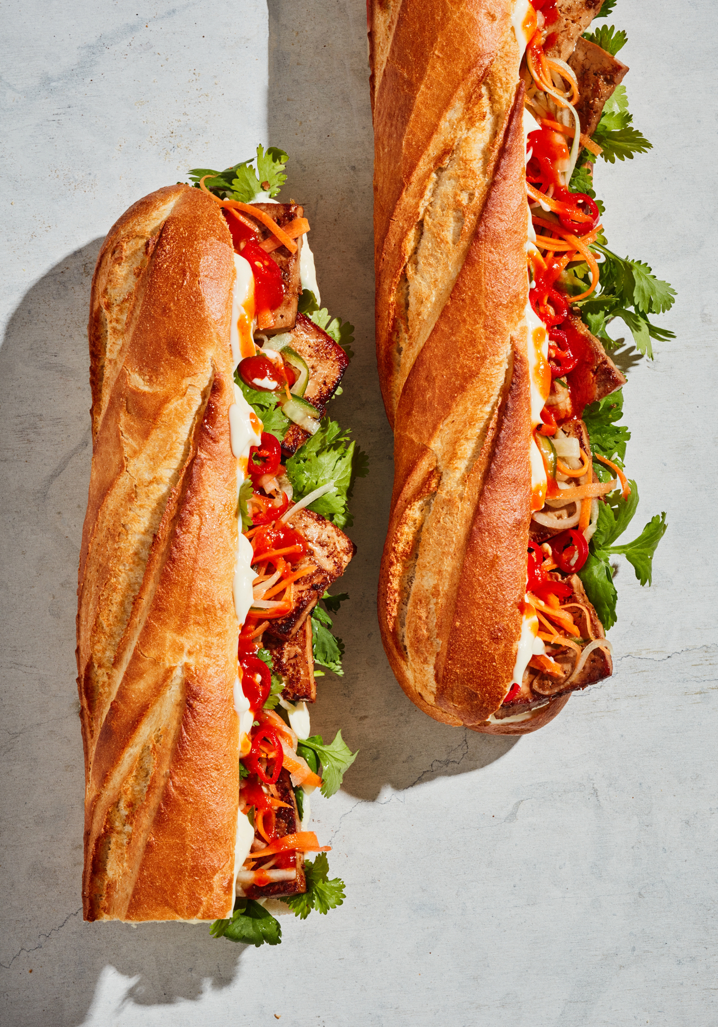 two sandwiches with meat and vegetables