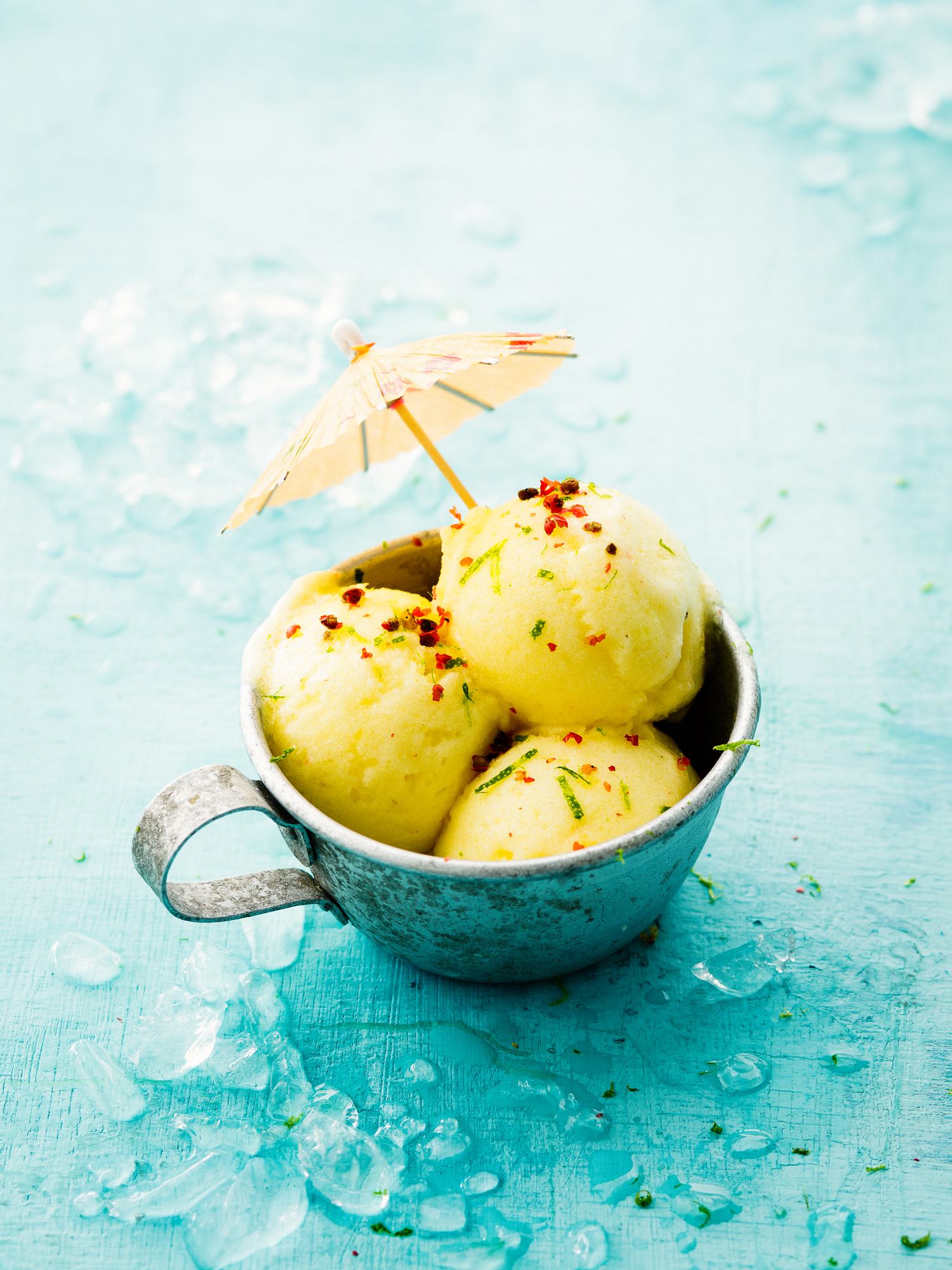 a cup of ice cream with a small umbrella