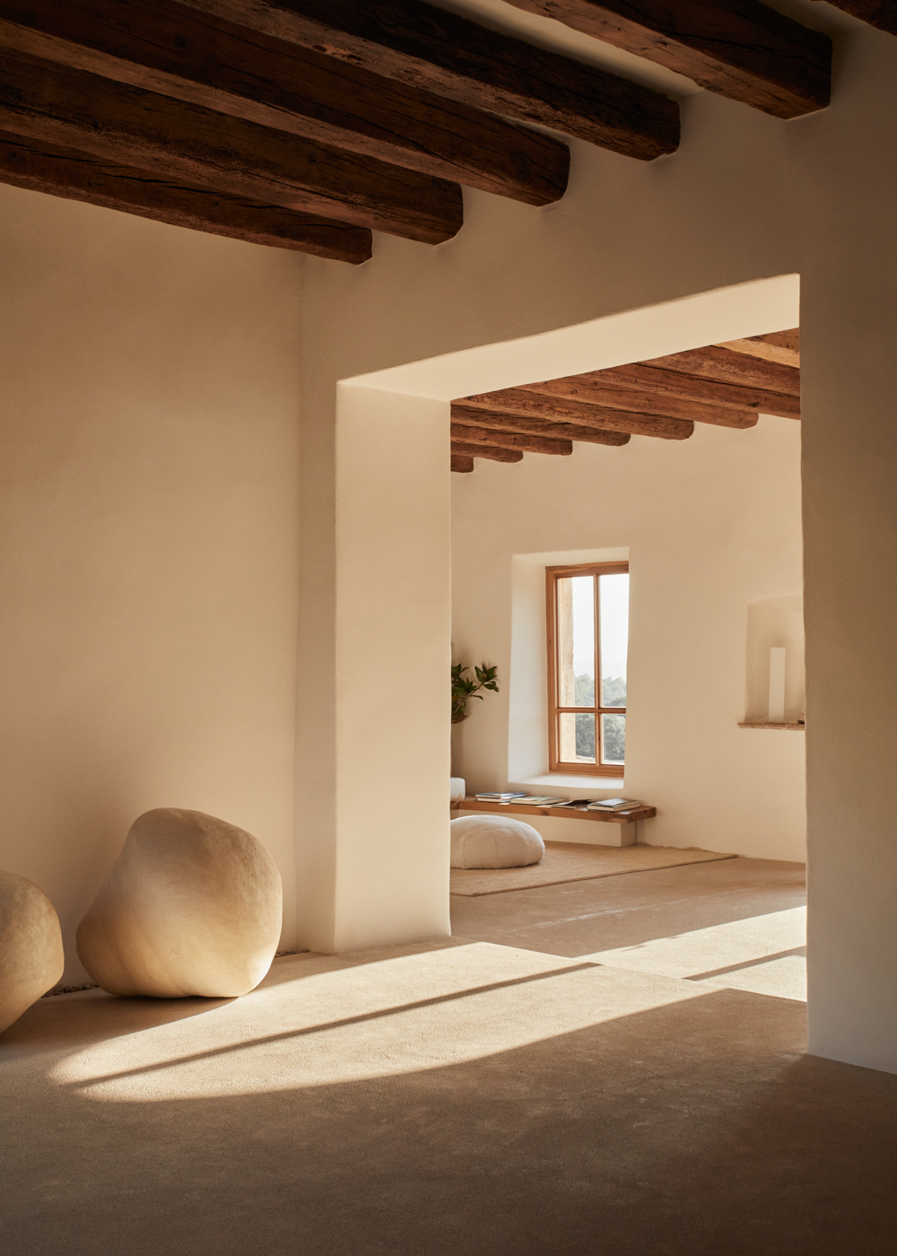 a room with white walls and a large stone object