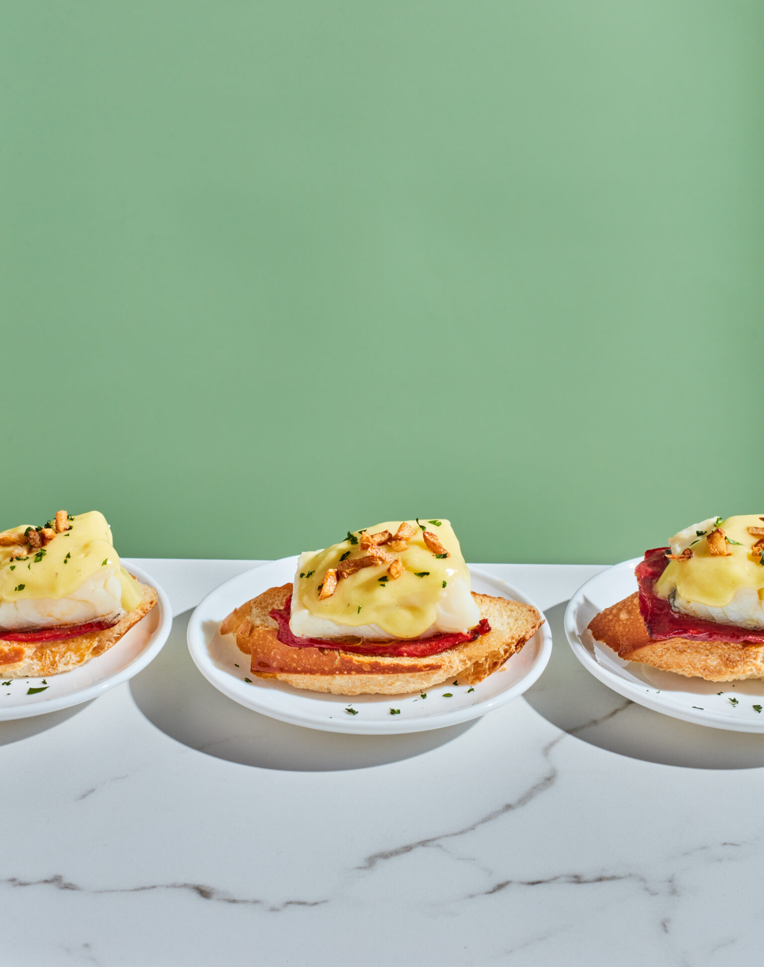 a row of small plates with food on them