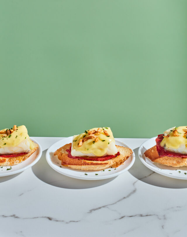a row of small plates with food on them