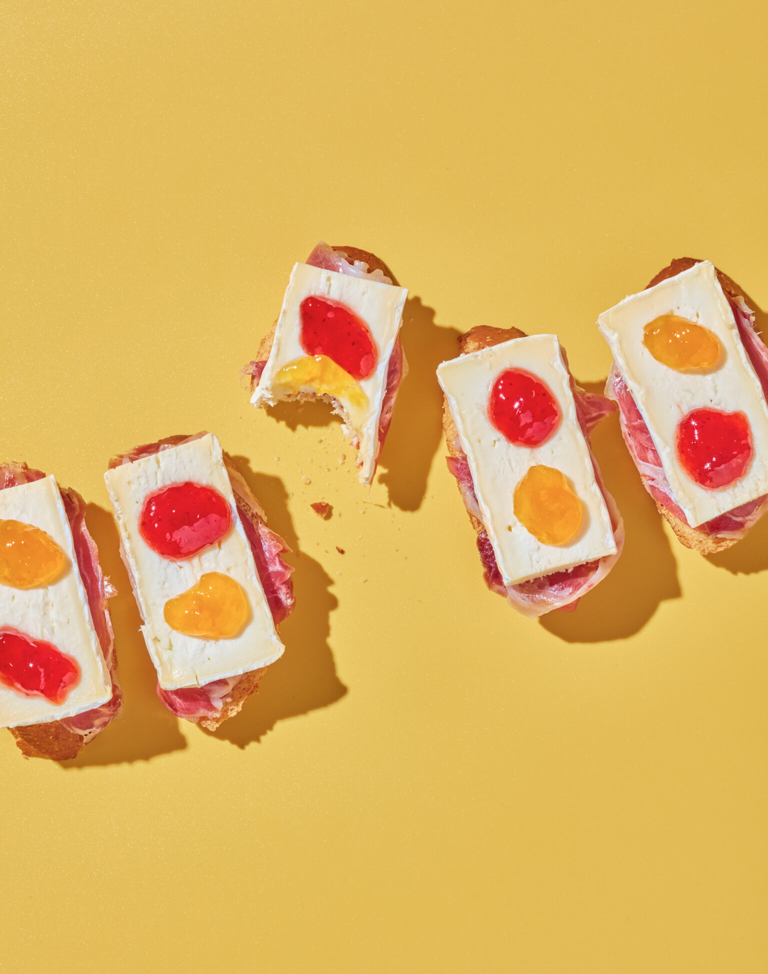 a group of sandwiches with different colored toppings
