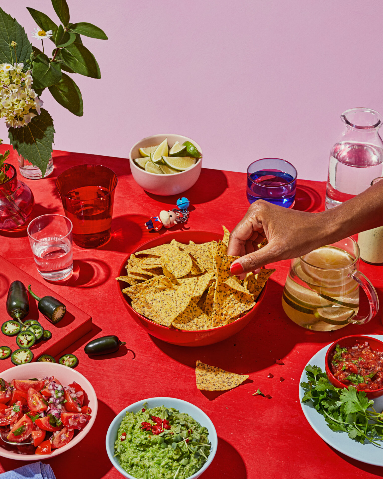 a person dipping chips into a bowl of food