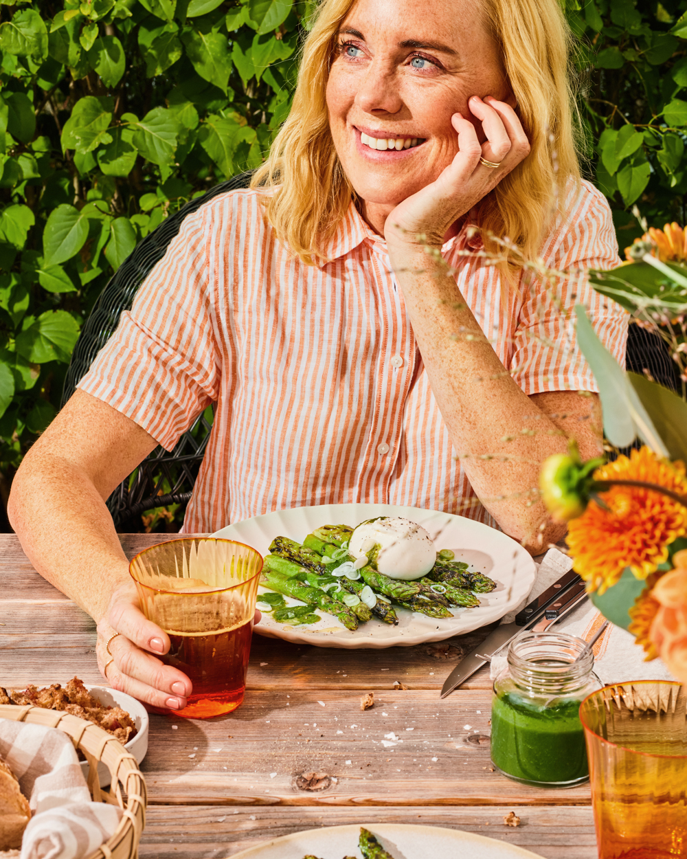 a woman sitting at a table with a plate of food