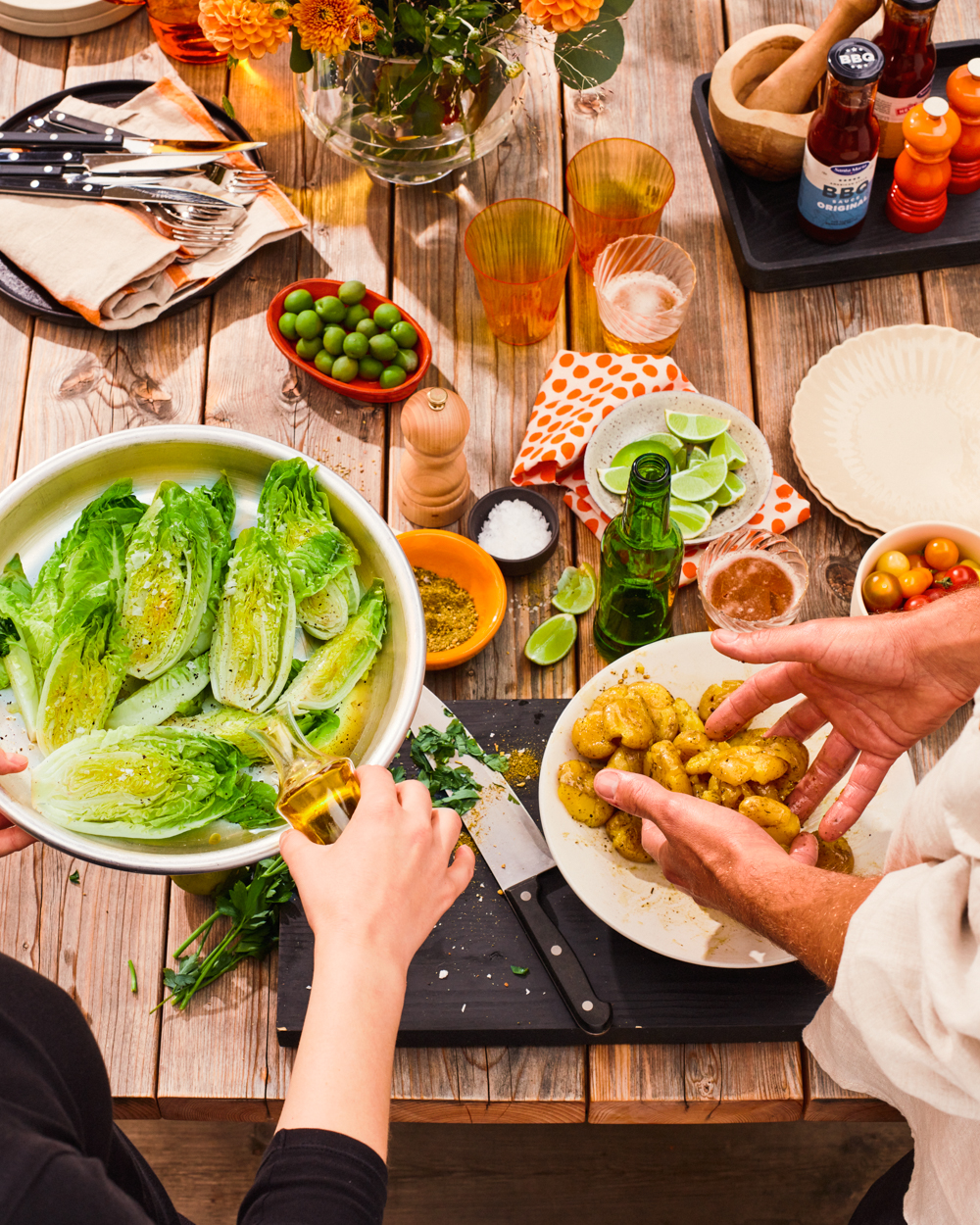 a person pouring a salad into a bowl