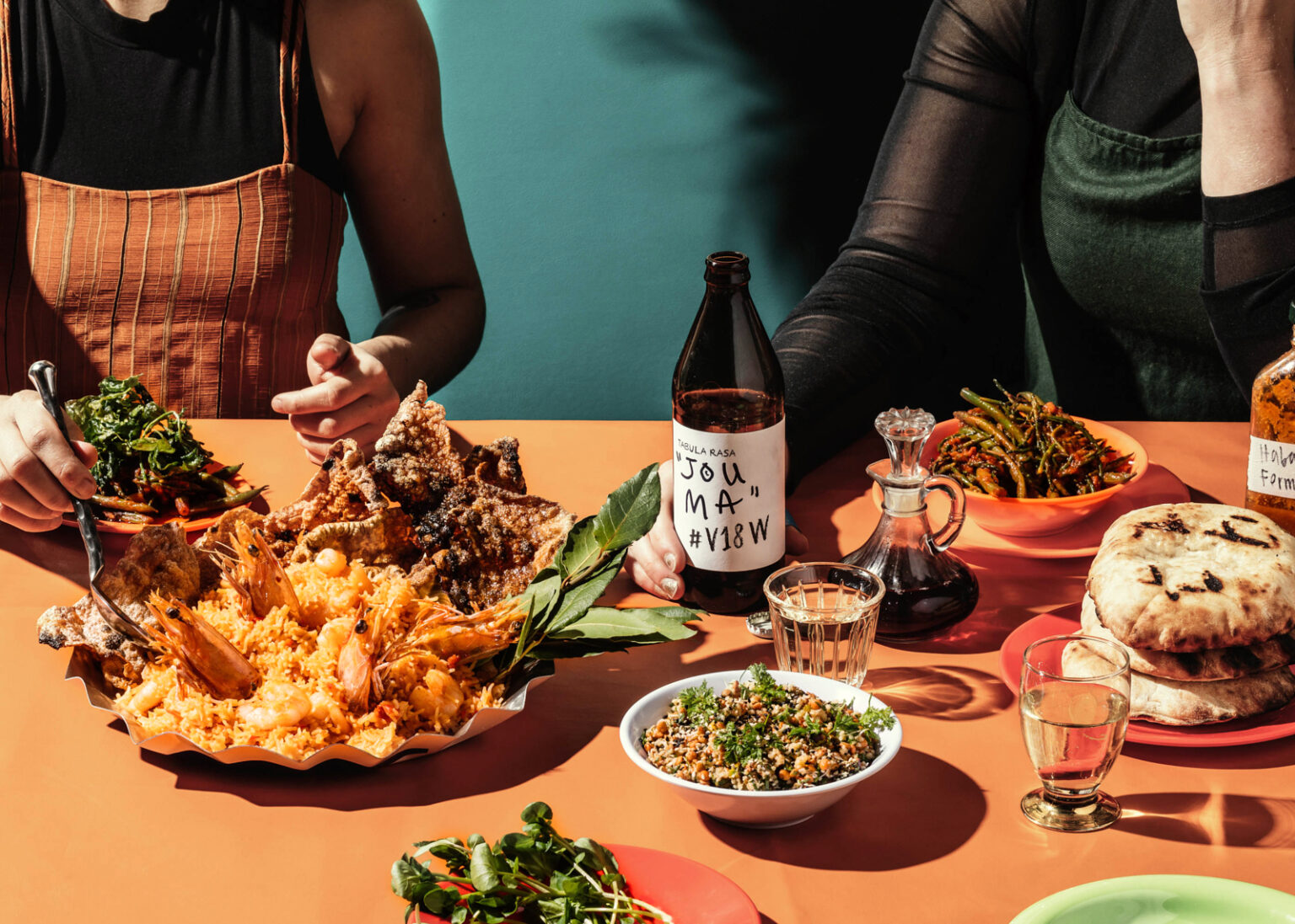 a group of people sitting at a table with food