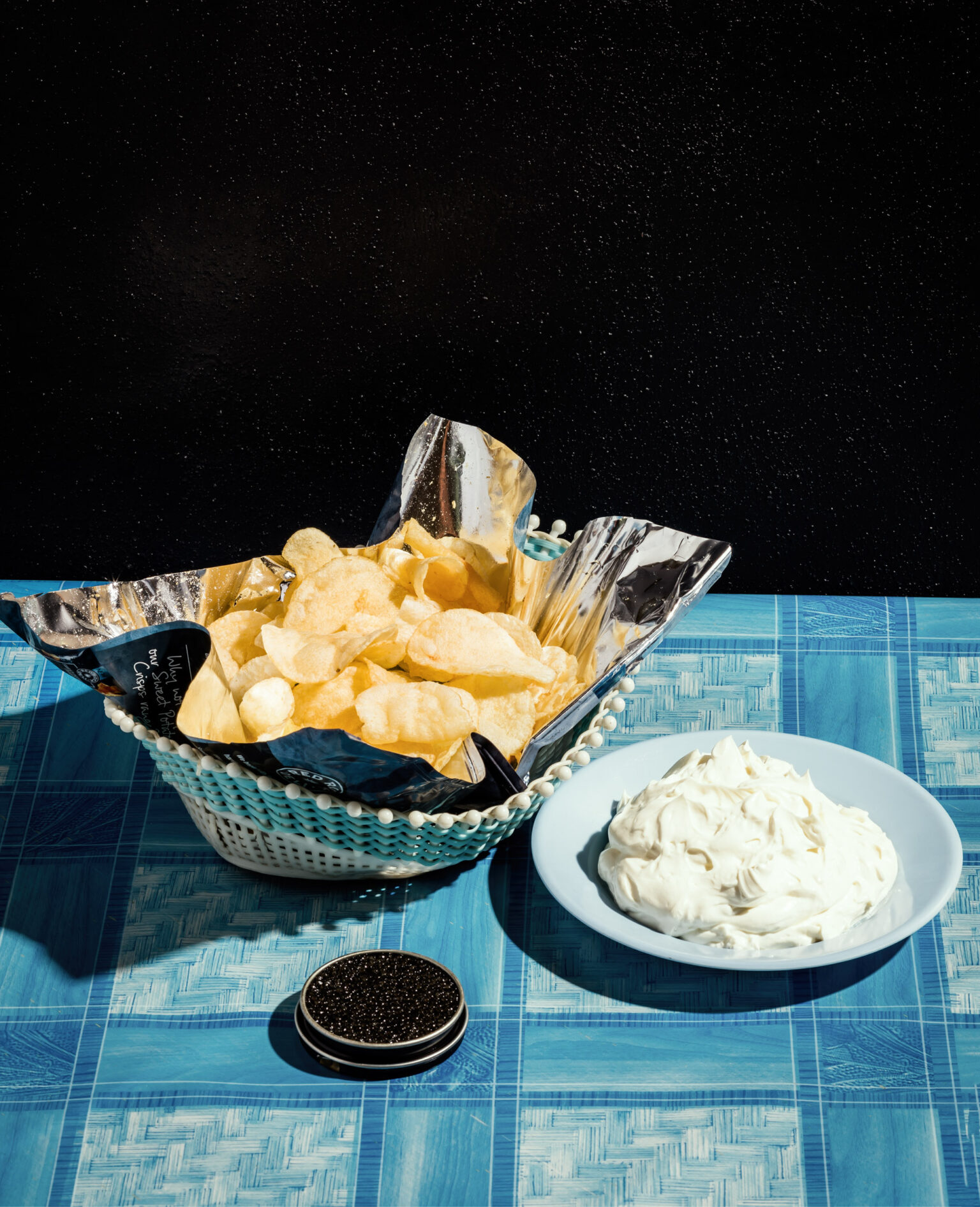 a basket of chips and a plate of cream cheese