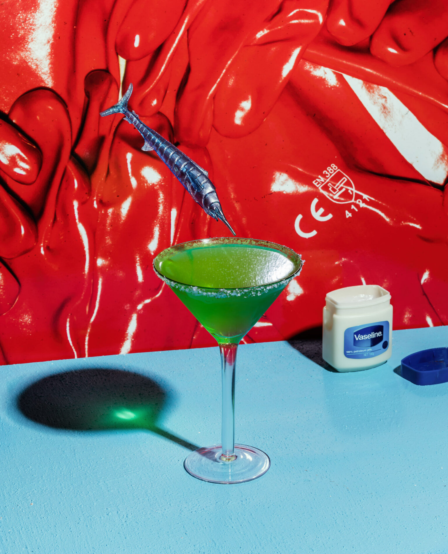 a glass with a green liquid in it