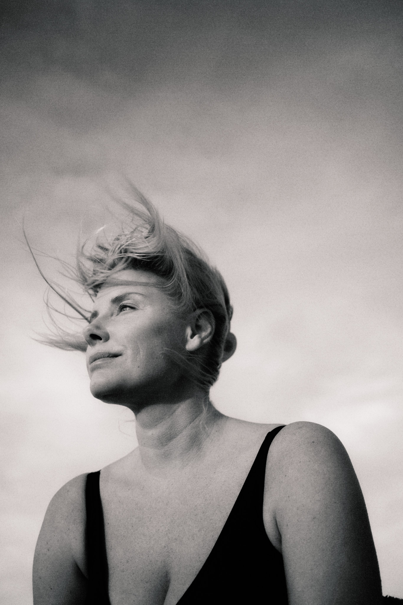 a woman with her hair blowing in the wind