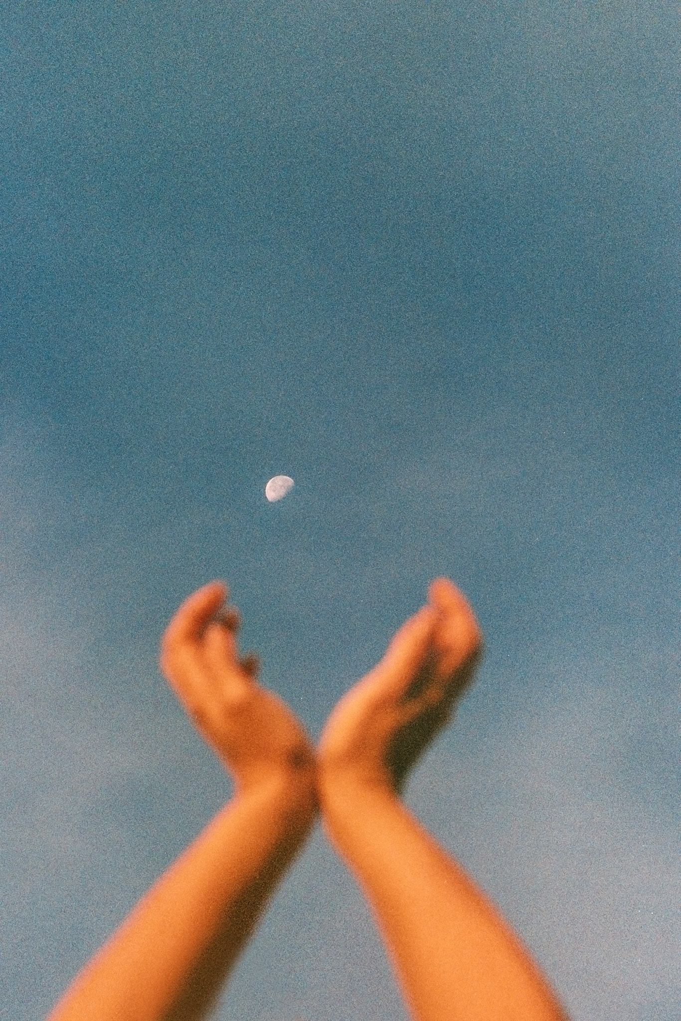 a hands reaching up to the sky