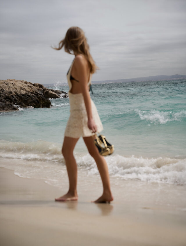 a woman walking on a beach