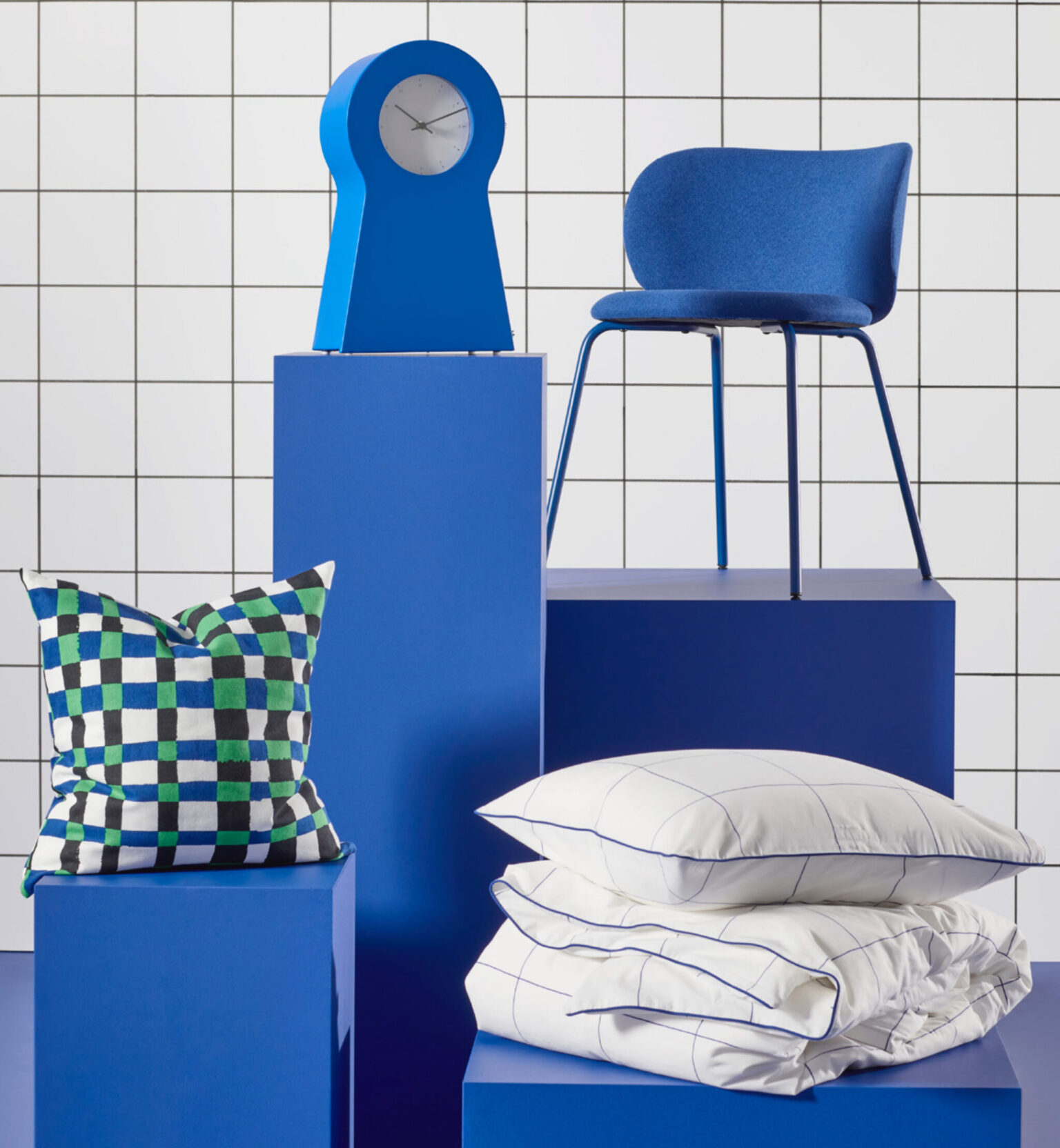 a blue and white display with pillows and a clock