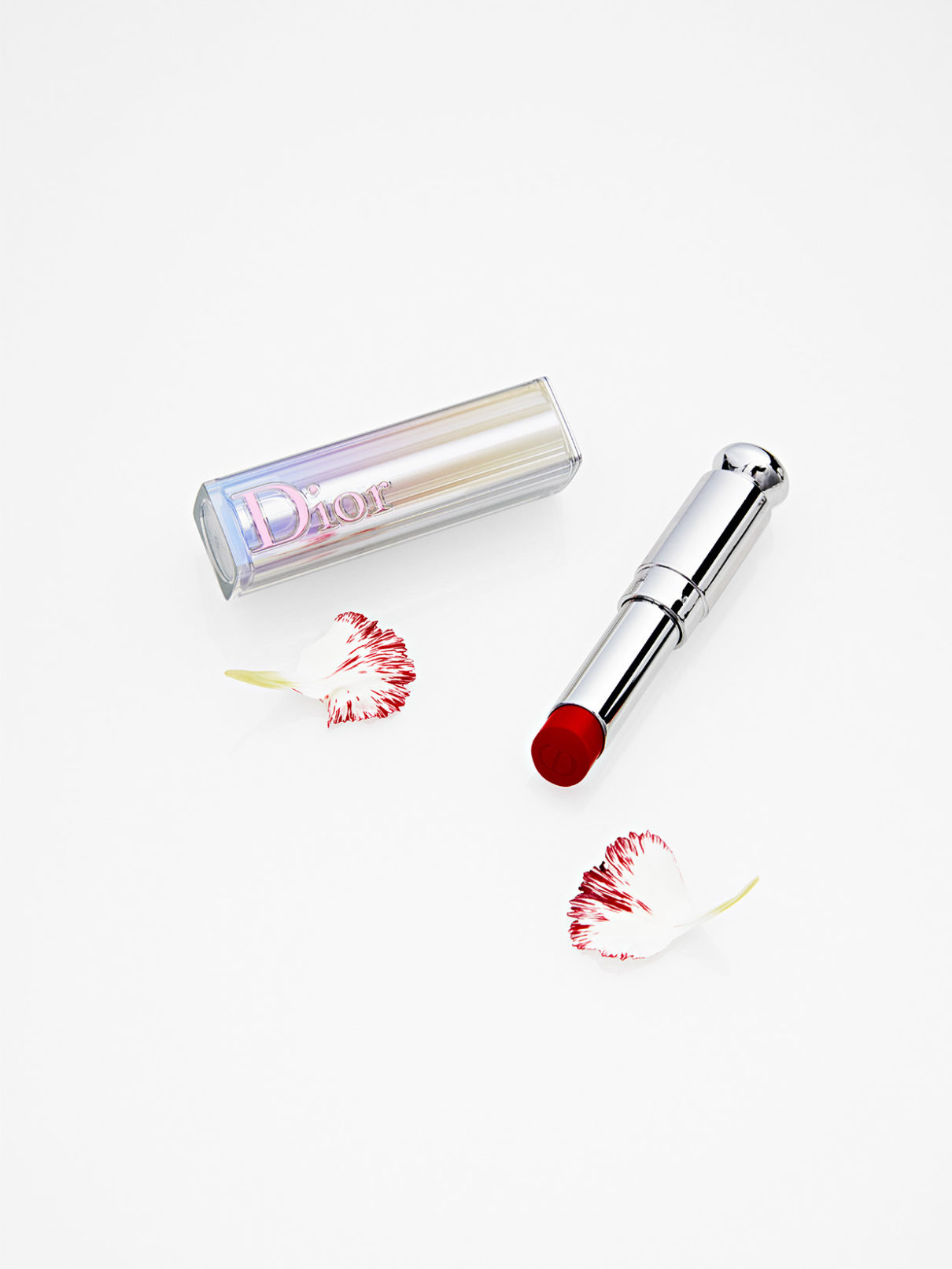 a lipstick and flower petals