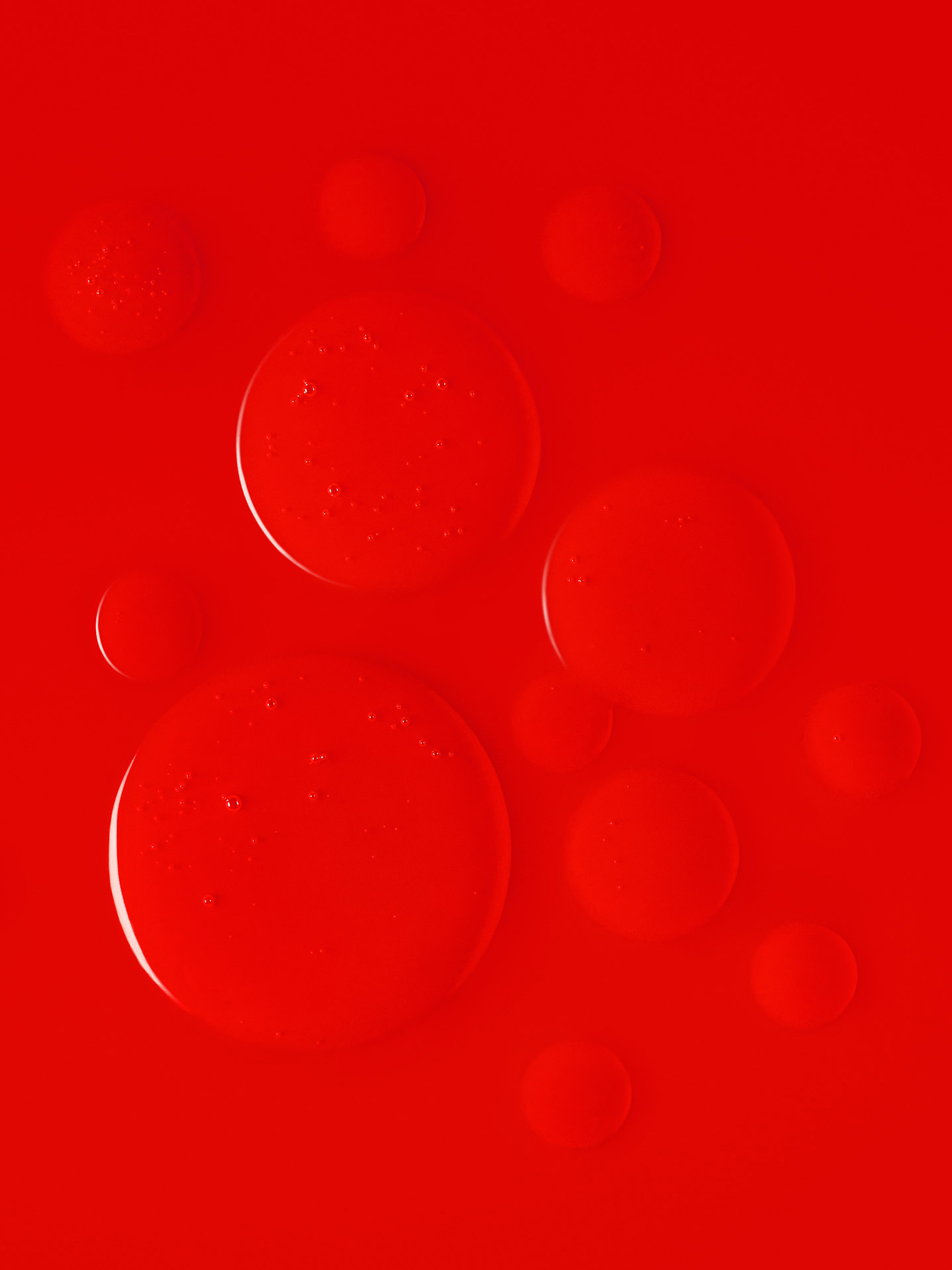 a group of bubbles on a red surface