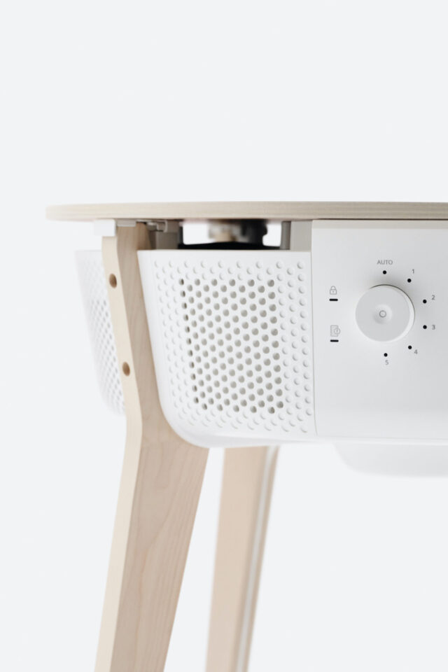 White air purifier with wooden legs and a wooden top, featuring a control dial.