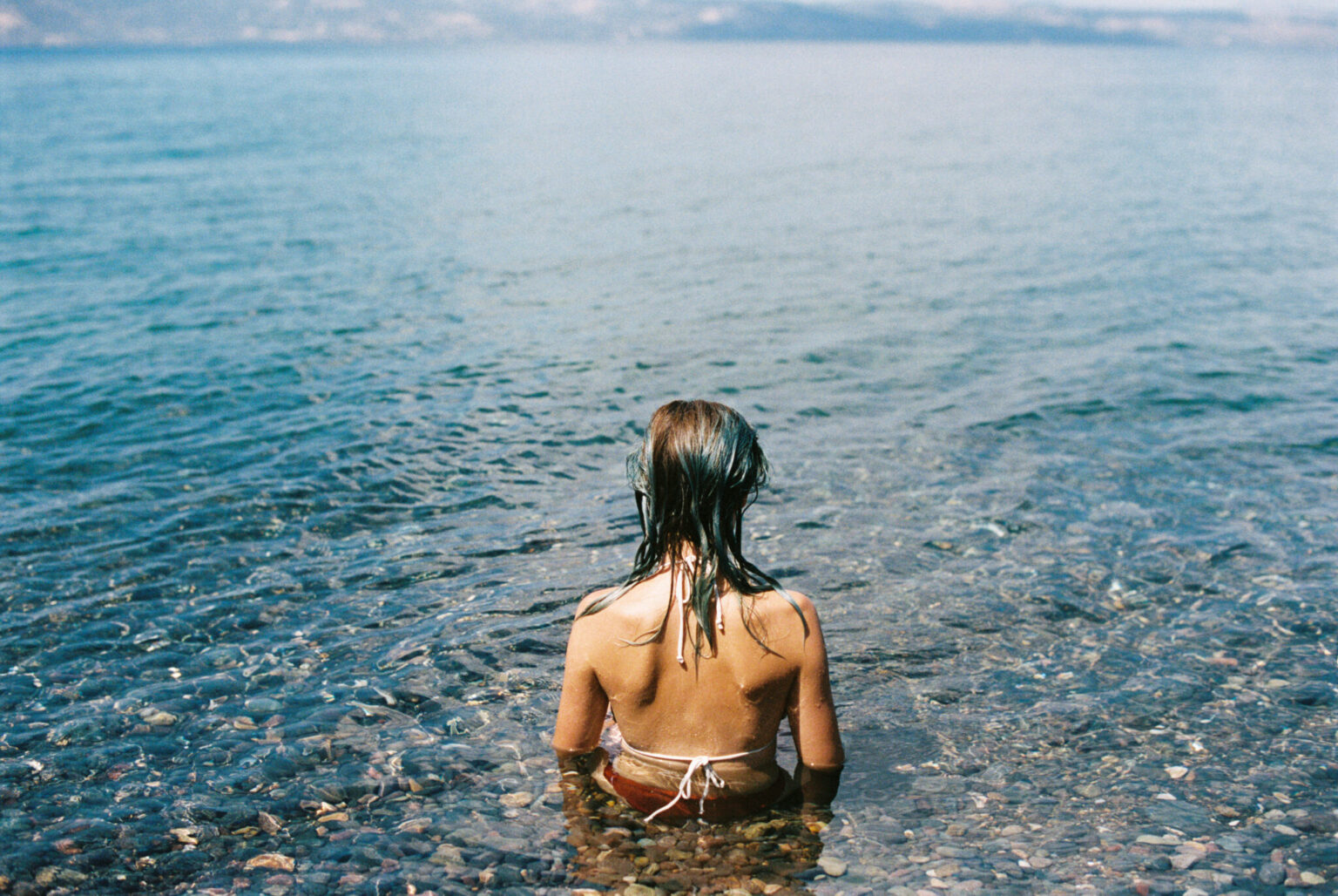 a woman sitting in the water