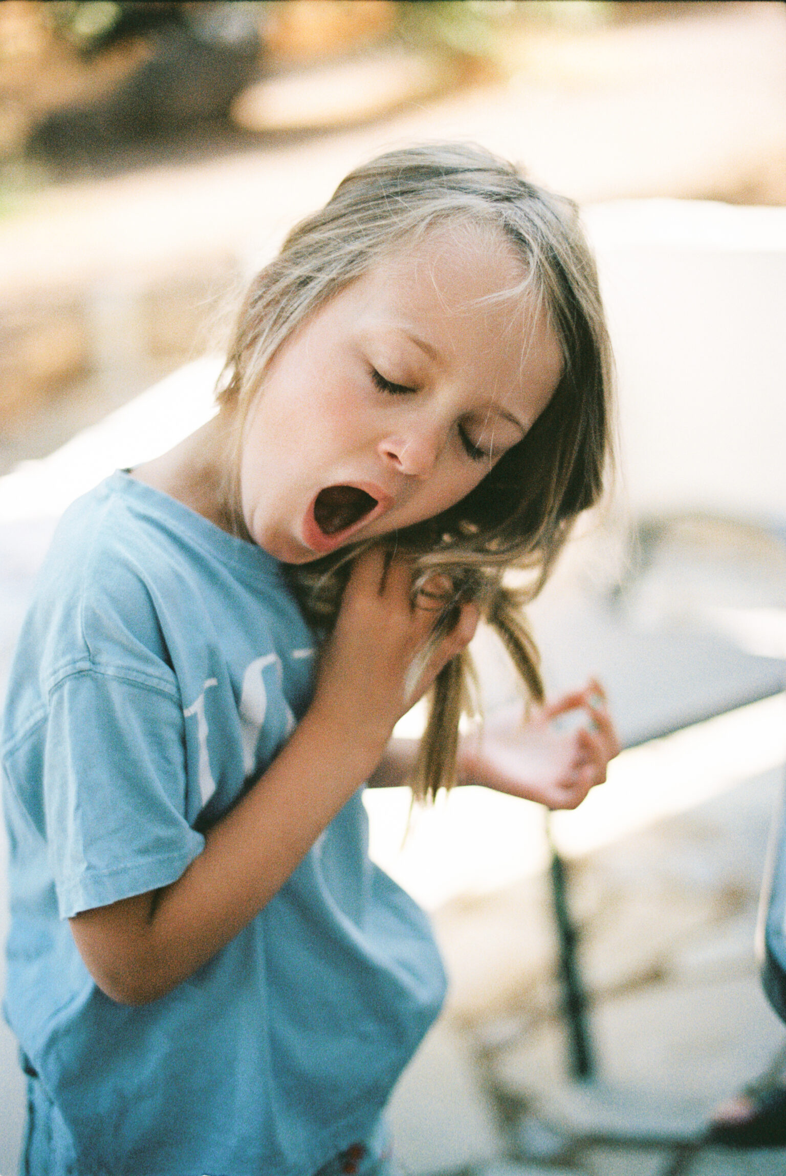 a girl yawning and looking at something