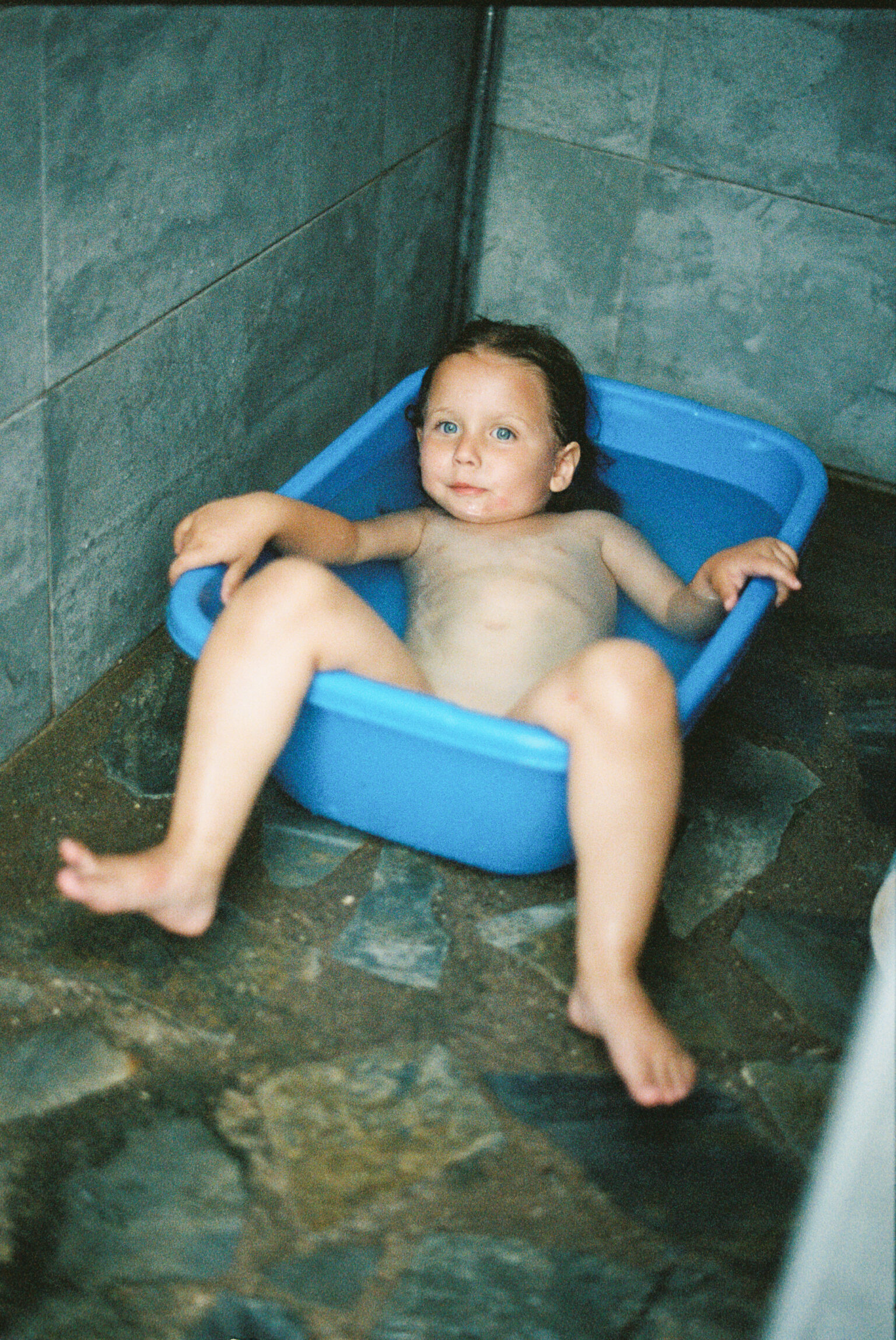 a child in a blue tub