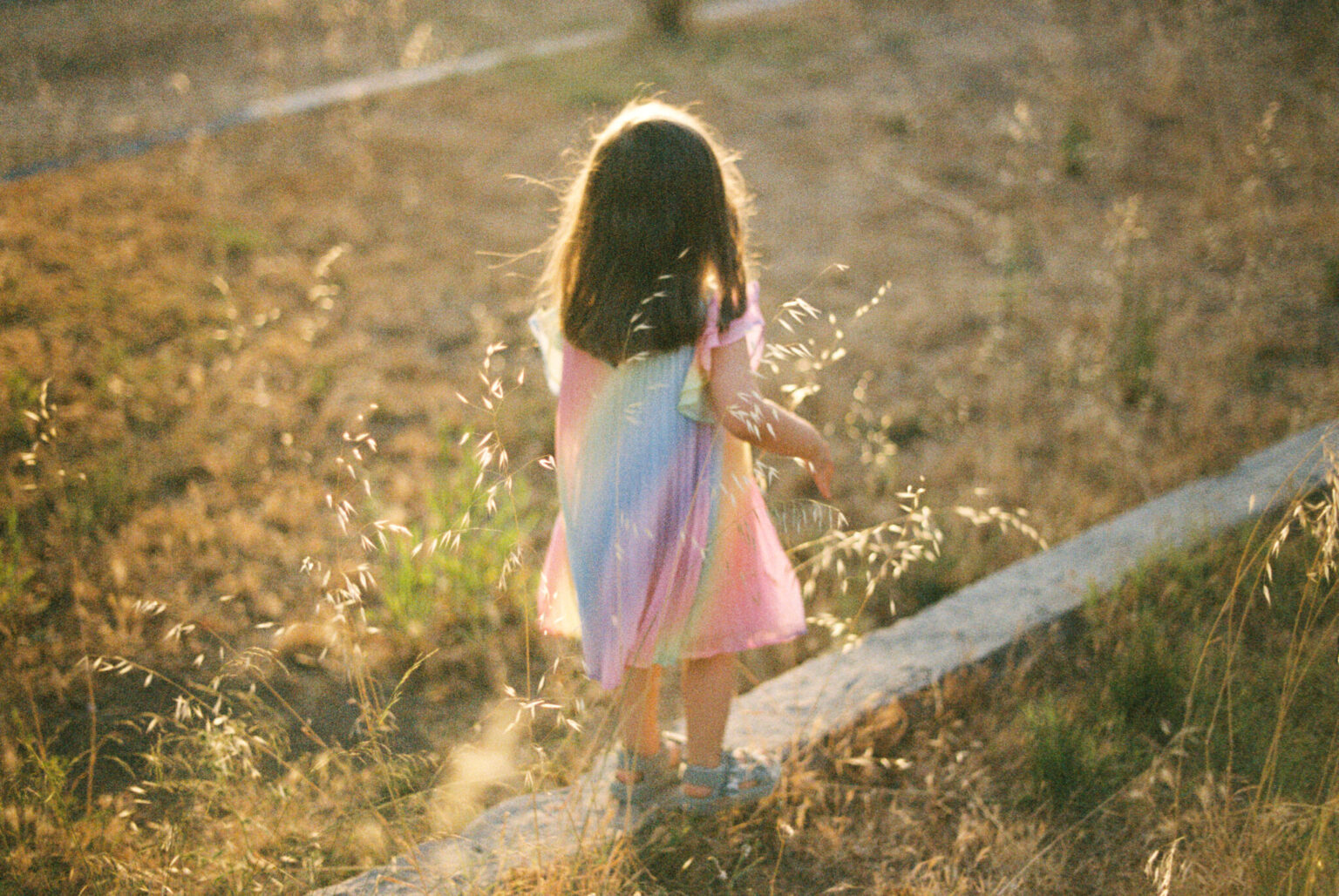 a girl standing on a curb